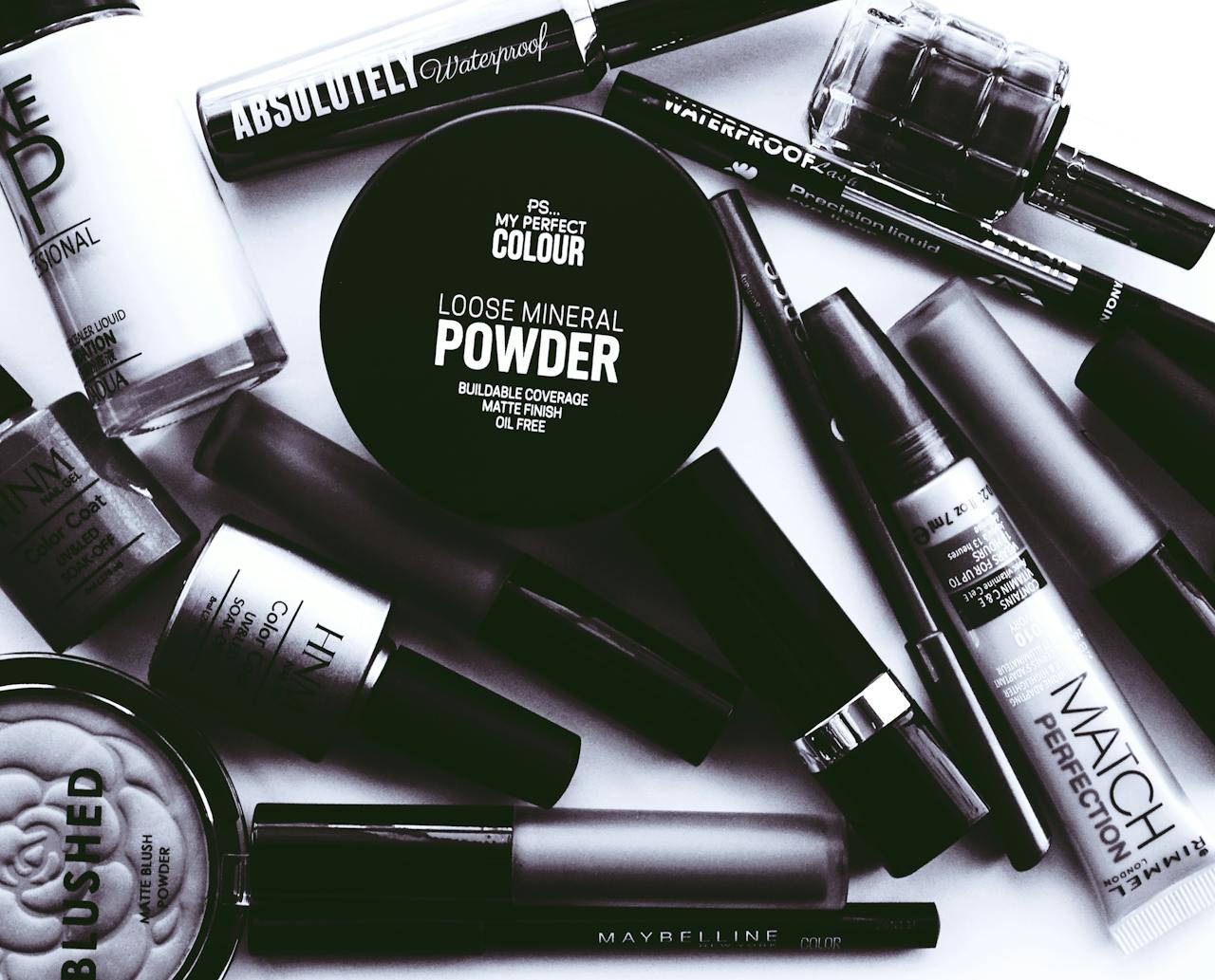 The Art of Drawing Readers In: Your attractive post title goes here Elegant monochrome flatlay showcasing a collection of beauty products and cosmetics.